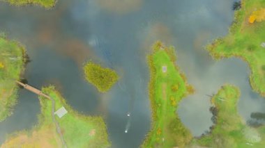 Amazing aerial foggy top-down view of Kirkilai karst lakelets in the bright autumn morning, the unique region with high concentration of sinkholes, exceptional water bodies. Birzai, Lithuania