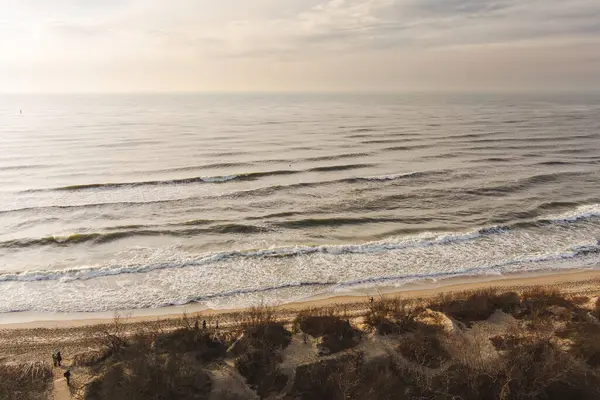 Aerial view of the Baltic Sea shore line near Klaipeda city, Lithuania. Beautiful sea coast on chilly and snowy winter day. Winter on Baltic sea.