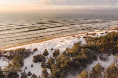 Litvanya 'nın Klaipeda kenti yakınlarındaki Baltık Denizi kıyı şeridinin hava görüntüsü. Soğuk ve karlı kış gününde güzel deniz kıyıları. Baltık denizinde kış.