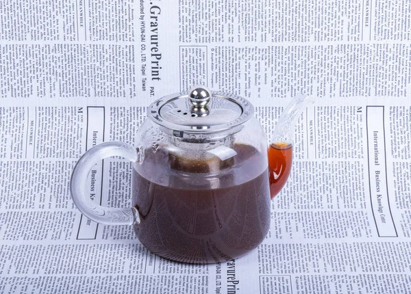 teapot on newspaper background