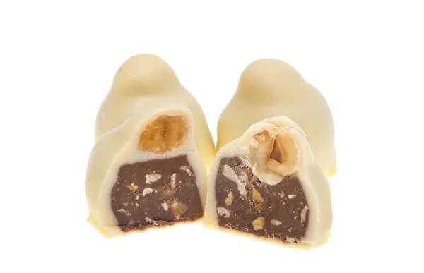在白色背景上分离出来的带有榛子的巧克力糖果 免版税图库图片