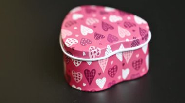 gift box with hearts on black background