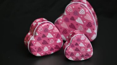 gift box with hearts on black background