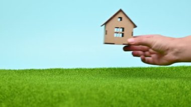 concept real estate on blue sky and green grass background