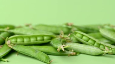 açık yeşil arkaplanda yeşil bezelye kabukları