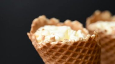 ice cream in a waffle cone on a black background