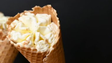 ice cream in a waffle cone on a black background