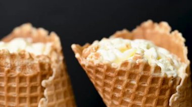ice cream in a waffle cone on a black background