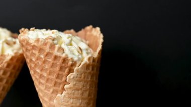 ice cream in a waffle cone on a black background