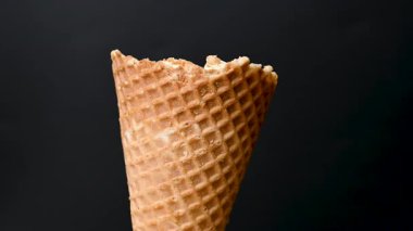 ice cream in a waffle cone on a black background