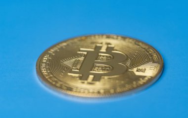 Bitcoin coin on blue background