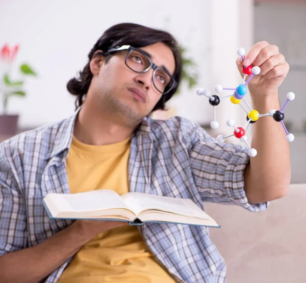 stock image The young student physicist preparing for exam at home