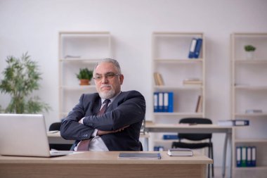 Ofiste çalışan eski bir işadamı.