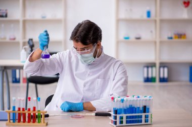 Laboratuvarda çalışan genç bir kimyager.