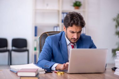 Genç işadamı ve işyerinde çok fazla iş var.