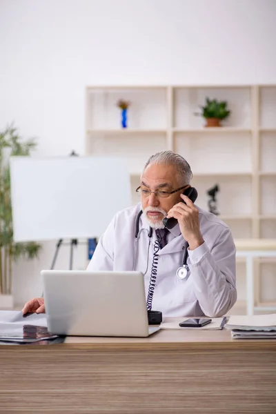 Old doctor in telemedicine concept
