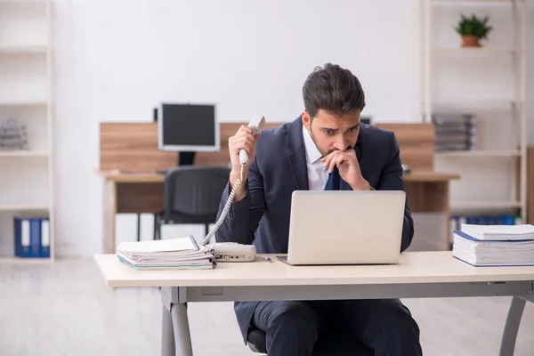 stock image Young businessman employee sitting at workplace