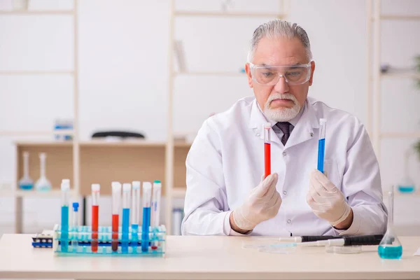 Old chemist working in the lab