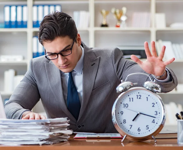 The young businessman in time management concept