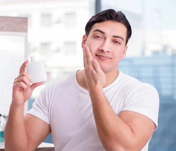Young Handsome Man Applying Face Cream — Stock Photo, Image