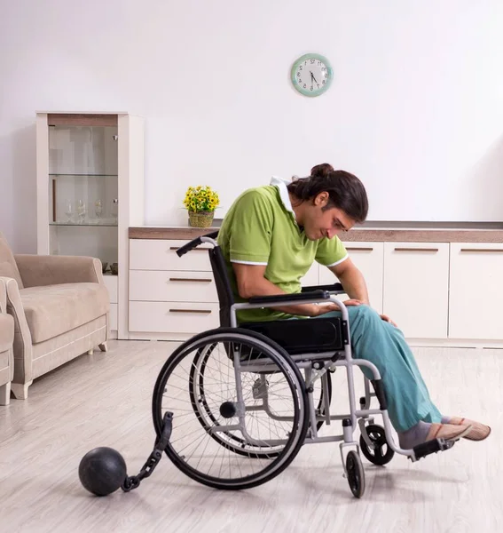 stock image The young male invalid in wheel-chair suffering at home