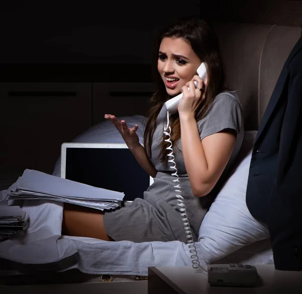 stock image The tired businesswoman working overtime at home at night