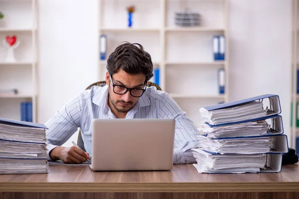 stock image Young businessman employee unhappy with excessive work in the office