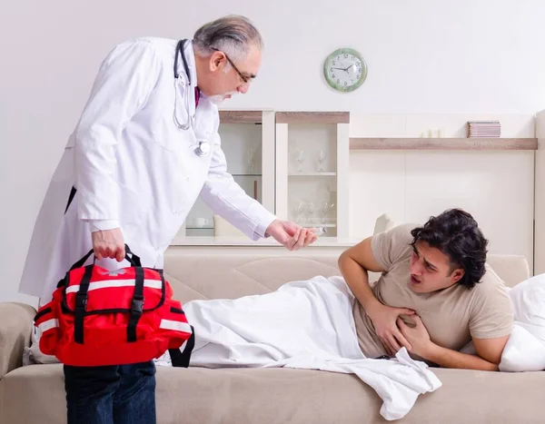Old Male Doctor Visiting Young Male Patient — Stock Photo, Image