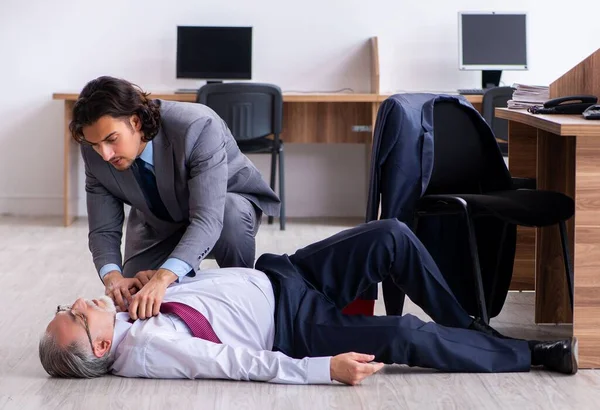 stock image The male employee suffering from heart attack in the office