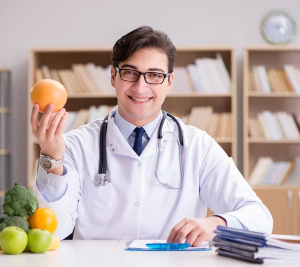 The doctor in dieting concept with fruits and vegetables