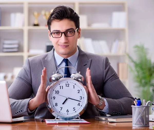 The young businessman in time management concept