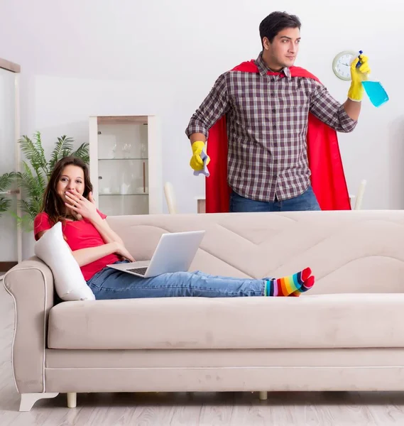 stock image The superhero husband helping his wife at home