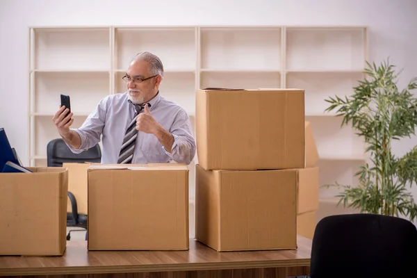 Old businessman employee in office relocation concept