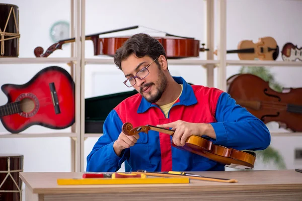 Young Man Repairing Musical Instruments Indoors — Stock Photo, Image