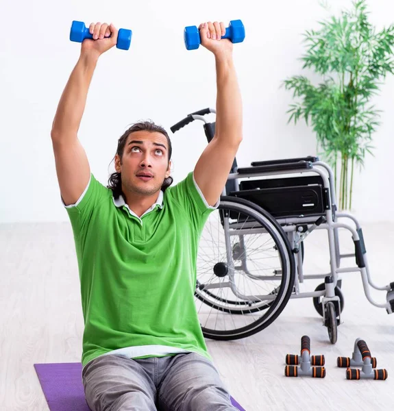 Młody Człowiek Wózku Inwalidzkim Ćwiczy Pomieszczeniu — Zdjęcie stockowe