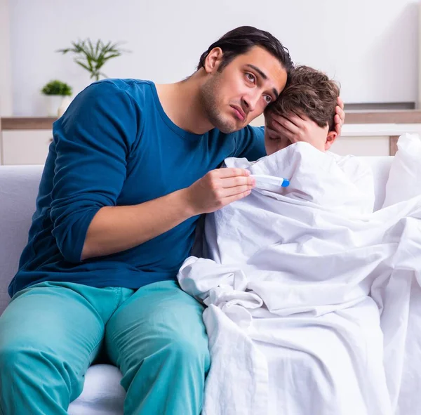 The young father caring for sick son