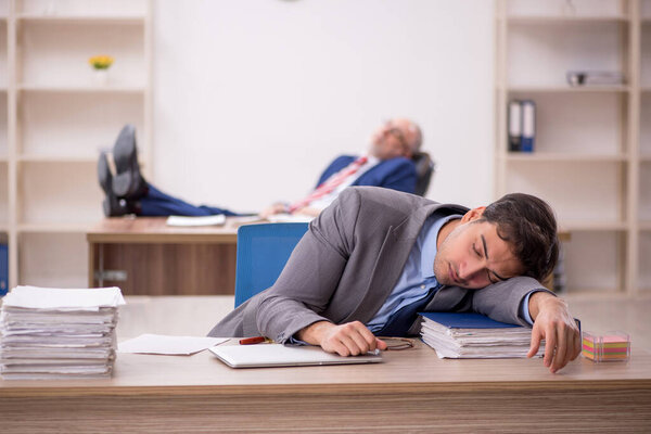 Two male colleagues sitting at workplace