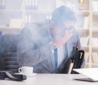 Ofisteki yangın alarmı sırasında işadamı.