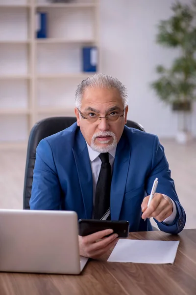 Old businessman employee working in the office