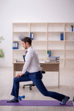 Mola sırasında spor yapan genç bir çalışan.