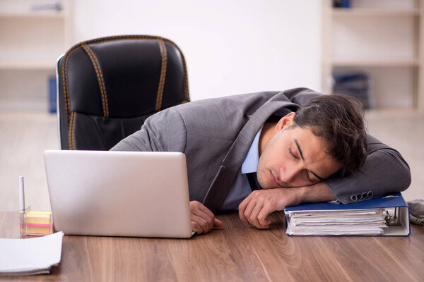 Young businessman employee sitting at workplace