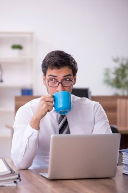 Genç işadamı ofisteki aşırı işten memnun değil.