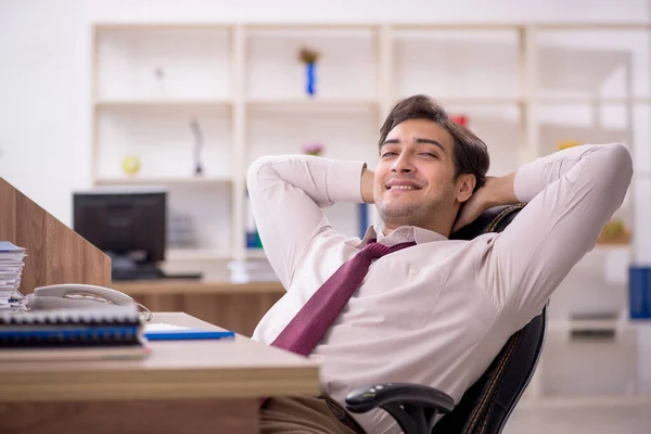Young businessman employee and too much work at workplace