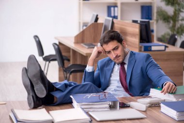 Genç işadamı işyerinde aşırı çalışmaktan memnun değil.