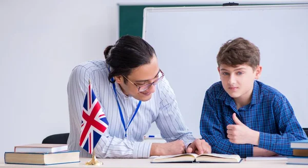 The male english teacher and boy in the classroom