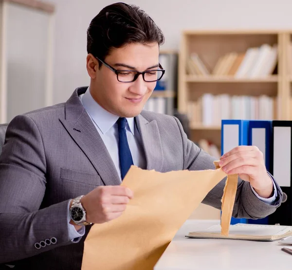 The businessman receiving letter envelope in office