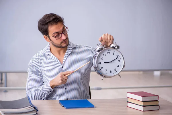 Young teacher in time management concept