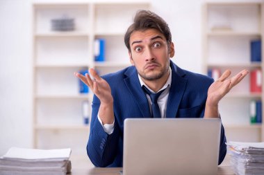 Genç işadamı ve ofiste çok fazla iş var.