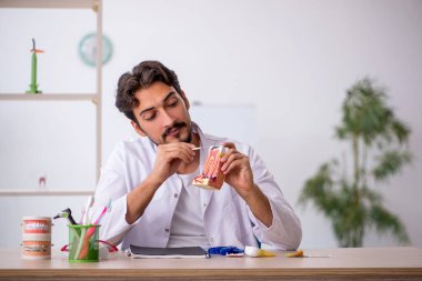 Klinikte çalışan genç bir dişçi.