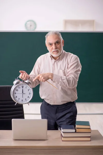 Old teacher in time management concept